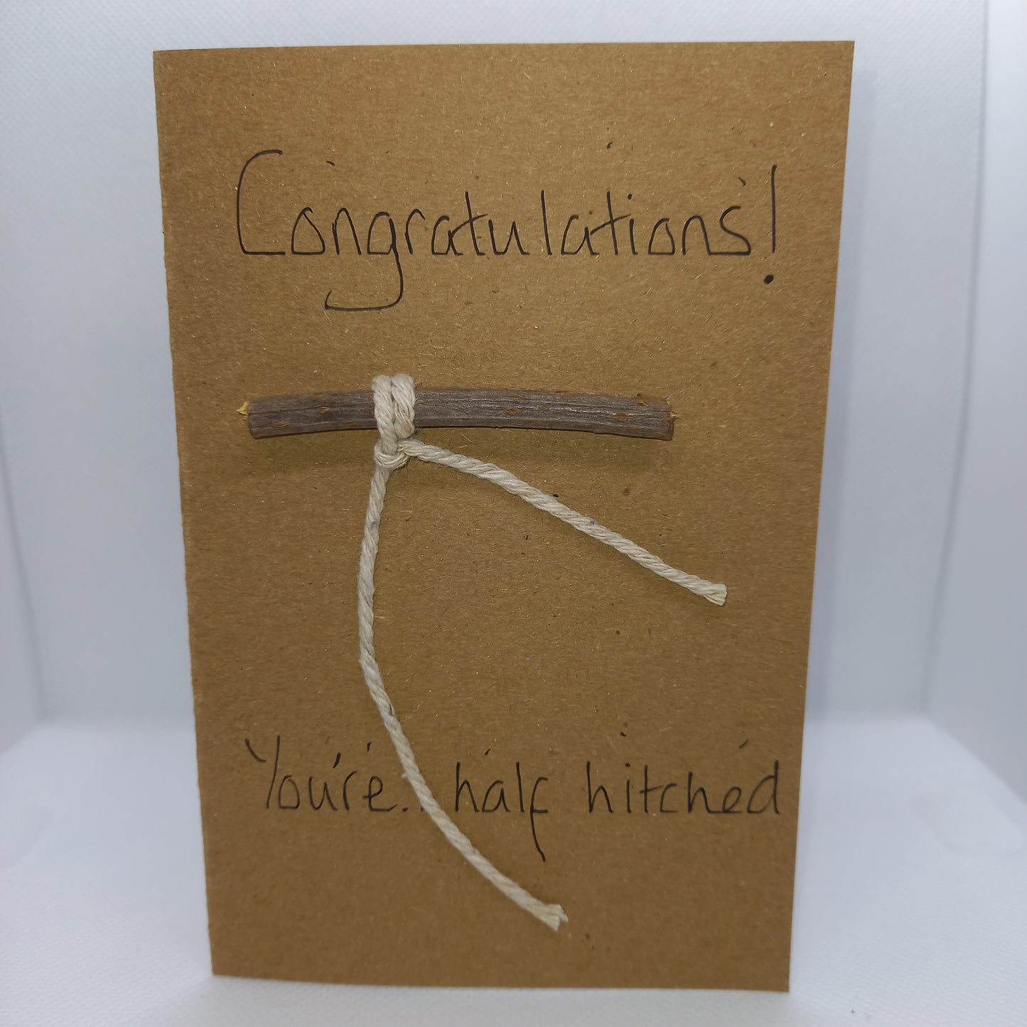 Congratulations on engagement card. Half hitch(ed) Knot on wood.